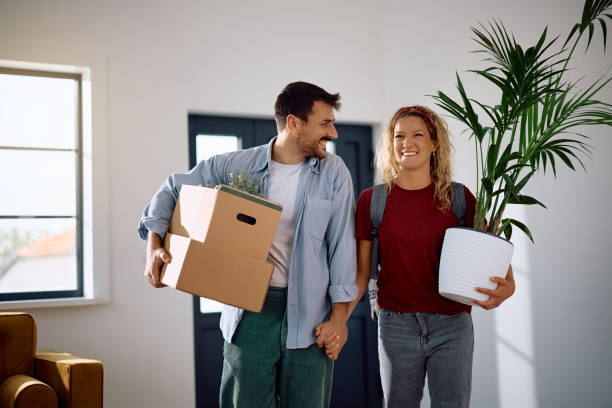 istock Happy couple holding hands while entering in their new apartment. 2172933310