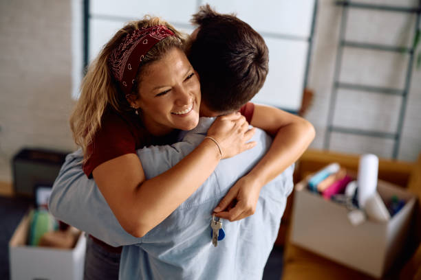 istock Joyful couple embracing while moving into new home. 2172933476