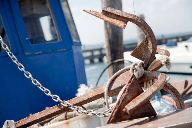 Metal anchor on a blue background