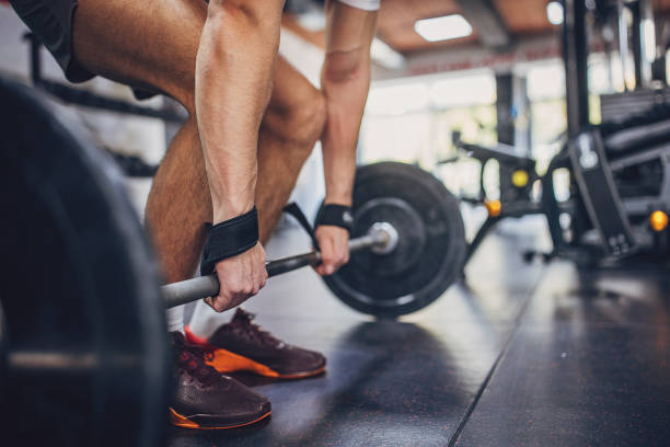 istock Person deadlifting barbell with focus on form and technique 2172937167