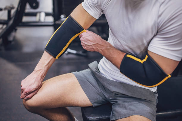 istock Person on gym bench wearing elbow support for training. 2172937440