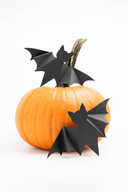 istock Pumpkin with black, paper bats isolated on white background with shadows.  Vertical. 2172937932