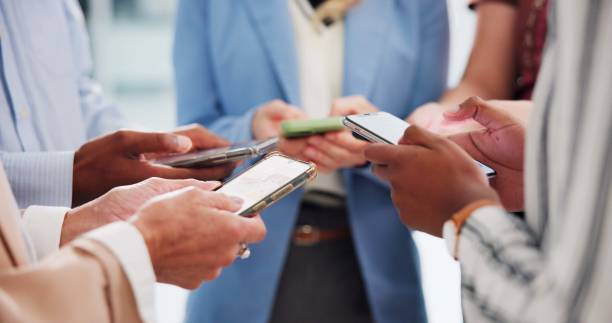 istock Business people, phone and hands for group networking in office for global connection and team chat. Technology, professional employees and smartphone for internet website and diverse community app 2172939919