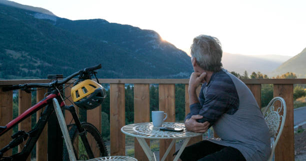 istock Mature man enjoys coffee on cabin veranda 2172942535