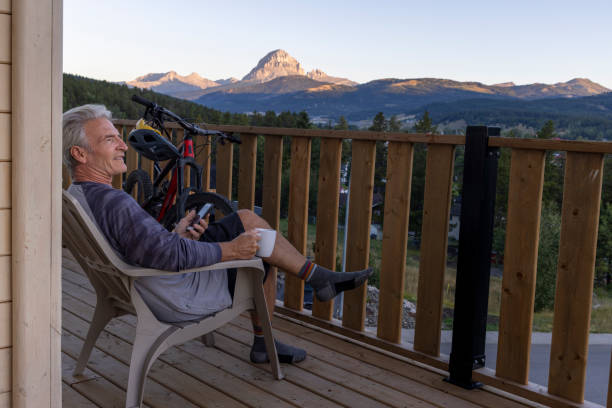 istock Mature man enjoys coffee on cabin veranda 2172942631