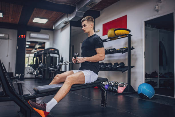 istock Athletic man engaged in seated cable row at gym 2172943988