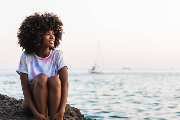 istock Delighted ethnic woman laughing at seaside 2172944308
