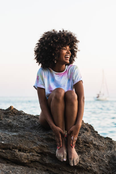 istock Delighted ethnic woman laughing at seaside 2172944323