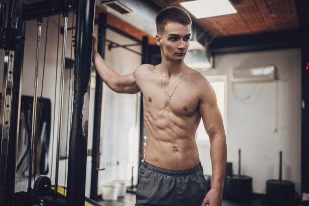 istock Confident bodybuilder posing with dumbbells in gym 2172944818