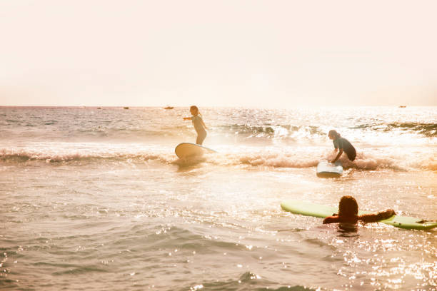 Carefree surfers having fun while learning to surfing