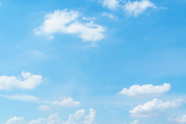 istock clear blue sky with fluffy white clouds creates serene and peaceful atmosphere, perfect for sunny day. vibrant colors evoke sense of calm and tranquility 2172945601