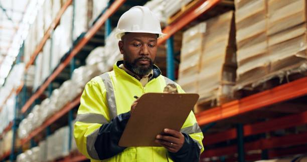 istock Black man, supervisor and clipboard at warehouse with counting or checklist, stocktake and delivery. Male person, employee and manufacturing for supplier in supply chain, logistics and wholesale 2172947887