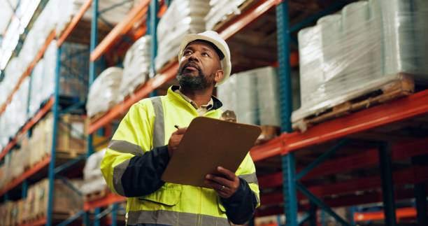 istock Warehouse, black man and tablet for stock management on logistic, quality control or inspection. Employee, tech and supervisor in maintenance for freight, supply chain and factory in shipping company 2172947891