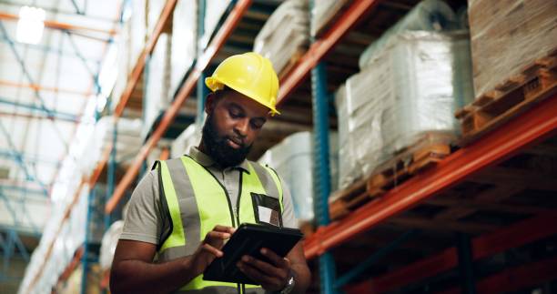 istock Tablet, worker and black man at warehouse for inventory, check stock and storage. Technology, logistics engineer and quality control at factory on app for distribution, shipping and safety inspection 2172947898