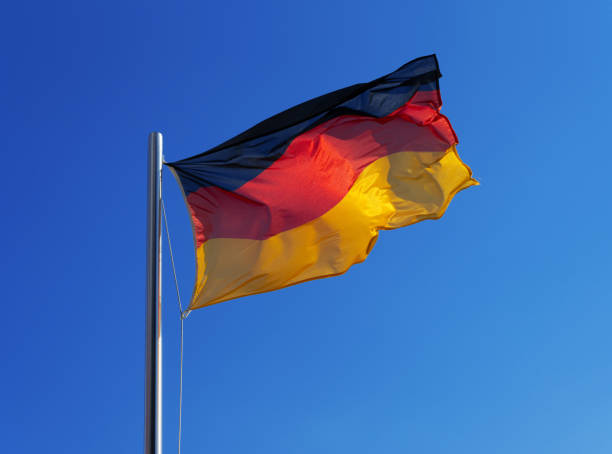German national flag in strong wind against blue sky