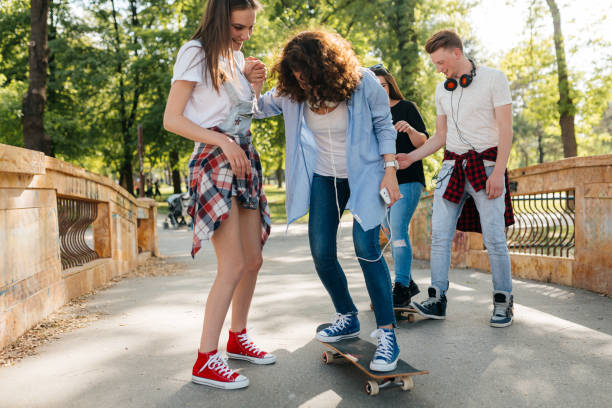istock Young people having fun skating with skateboard in the park 2172951474