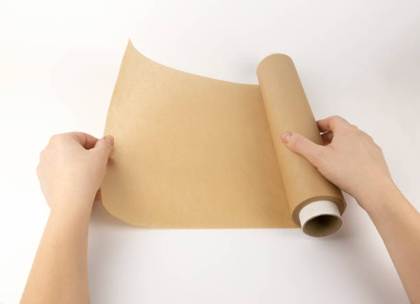 istock Parchment paper for baking in women's hands. A roll of paper. 2172954927