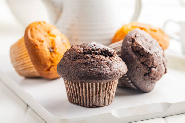 istock Sweet muffin cakes on cutting board on white table. 2172955799