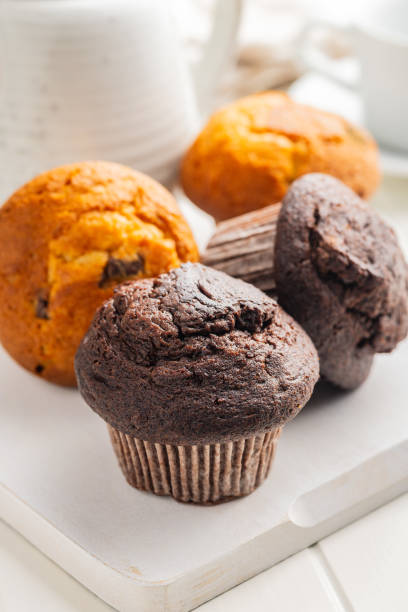 istock Sweet muffin cakes on cutting board on white table. 2172955829