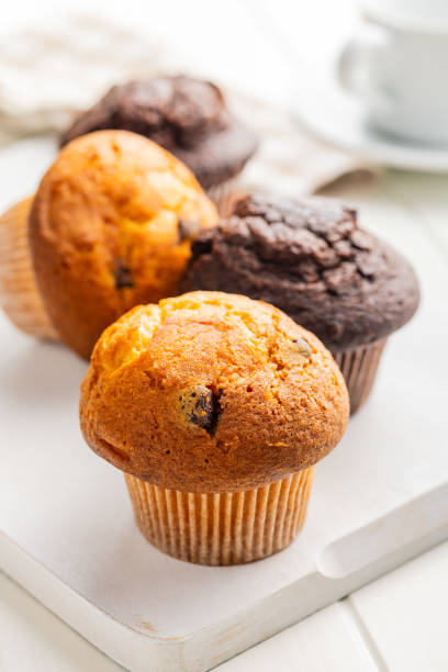 istock Sweet muffin cakes on cutting board on white table. 2172955831