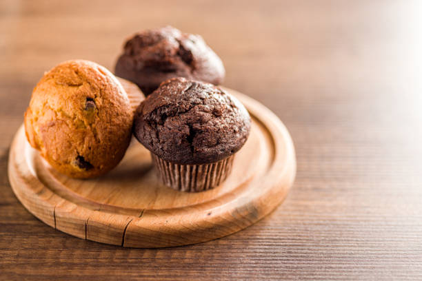 istock Sweet muffin cakes on cutting board on wooden table. 2172956036