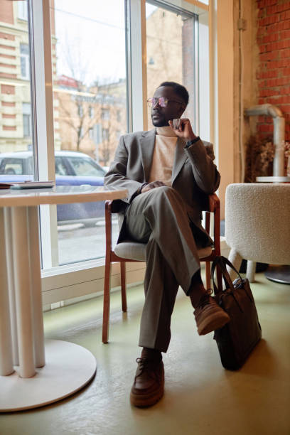 istock Relaxing in Modern Cafe Wearing Stylish Beige Suit 2172956212