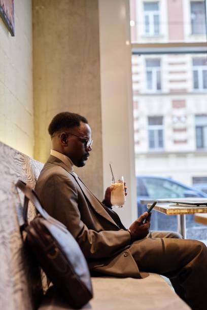 istock African American Man Relaxing in Modern Cafe Setting 2172956224