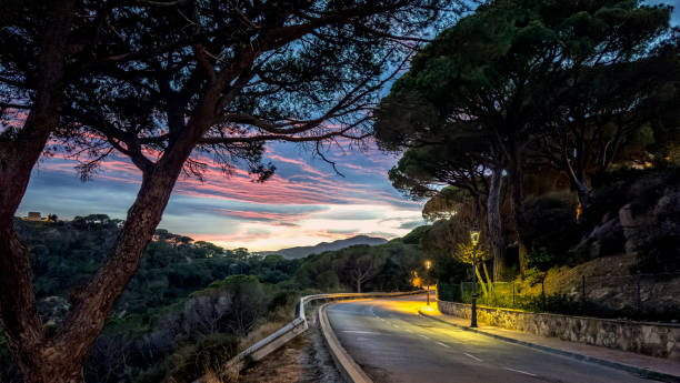 Curve hilly road against twilight sky
