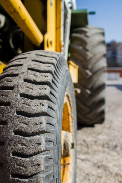 Worn Tires Of A Yellow Construction Vehicle