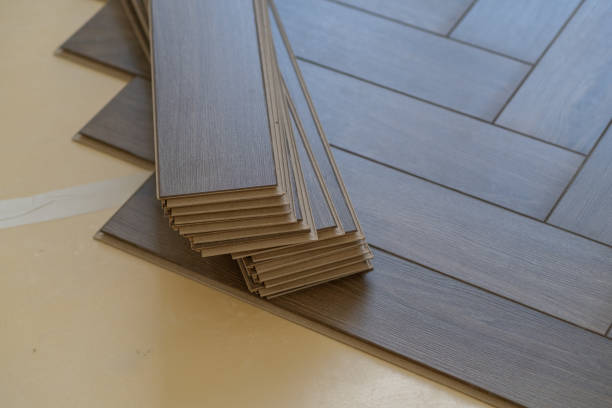 istock Handyman installing laminate flooring in a residential apartment. Step-by-step 2172968540