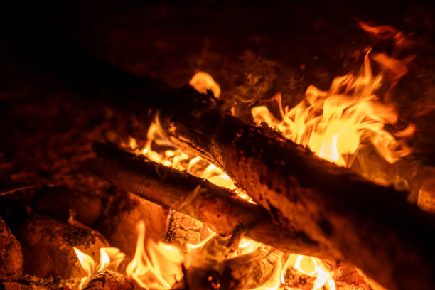 istock Logs burn brightly in a campfire, casting an inviting glow and warmth during a serene evening in the forest 2172970153