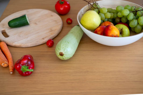 fruits and vegetables on a wooden table in the kitchen