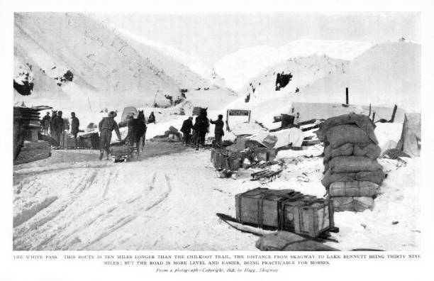 White Pass Route, Alaska, United States and British Columbia, Canada, Klondike Gold Rush, 19th Century North American History Prospectors at White Pass, Alaska, USA. Engraving published 1899. Original edition is from my own archives. Copyright has expired and is in Public Domain. alaska gold rush stock illustrations