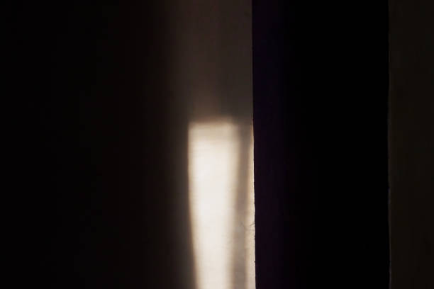 istock Sunlight entering through the window in a dark room 2172999609