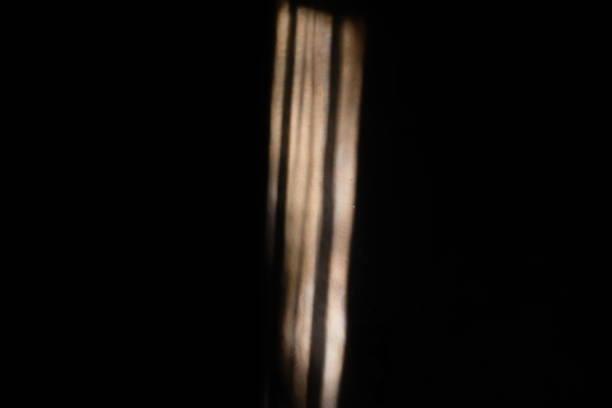 Sunlight entering through the window in a dark room