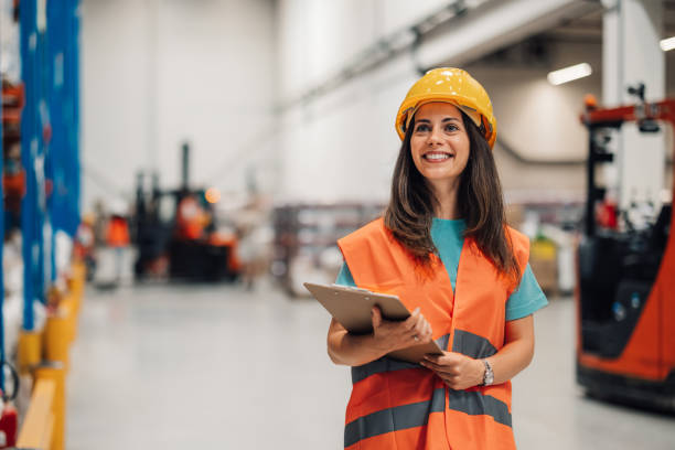 istock Female content warehouse assessor evaluates inventory amidst stacks 2172999897