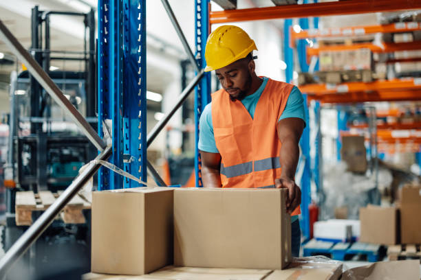 istock African american warehouse worker handling boxes in storage area 2172999904