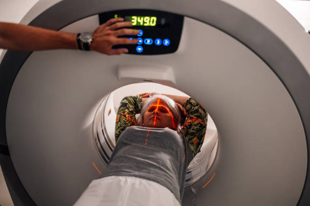 istock Patient undergoing CT scan with visible laser beams in hospital room. 2172999984