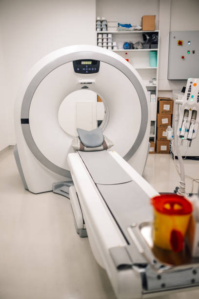 istock Empty CT scan machine bed awaiting next patient in imaging room. 2172999985