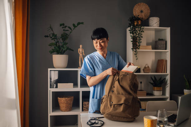 Dedicated asian female nurse preparing medical tools and documents for work