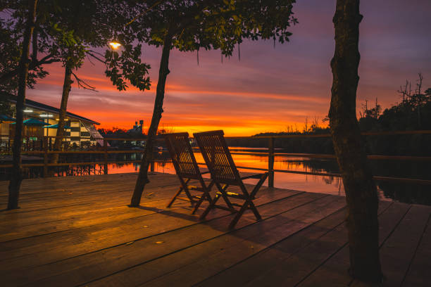istock Two Chairs by the Wain river at romantic sunset. 2173000060