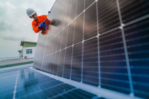 istock engineer man inspects construction of solar cell panel or photovoltaic cell by electronic device. Industrial Renewable energy of green power. factory worker working on tower roof. 2173001615