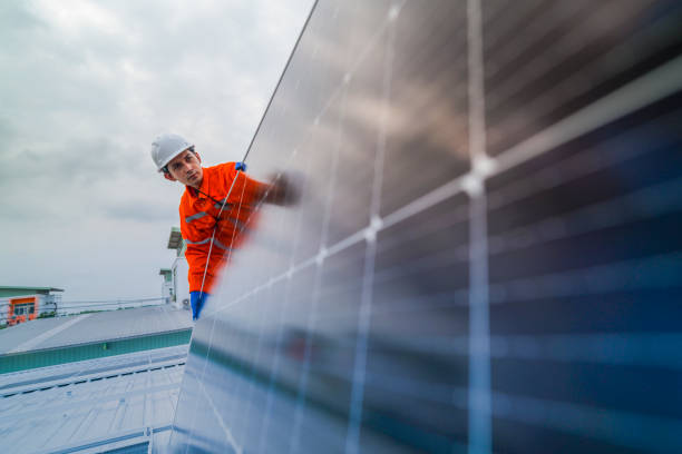 istock engineer man inspects construction of solar cell panel or photovoltaic cell by electronic device. Industrial Renewable energy of green power. factory worker working on tower roof. 2173001954