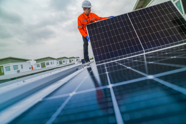 istock engineer man inspects construction of solar cell panel or photovoltaic cell by electronic device. Industrial Renewable energy of green power. factory worker working on tower roof. 2173002168
