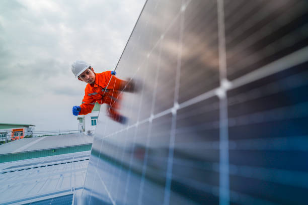 istock engineer man inspects construction of solar cell panel or photovoltaic cell by electronic device. Industrial Renewable energy of green power. factory worker working on tower roof. 2173002806