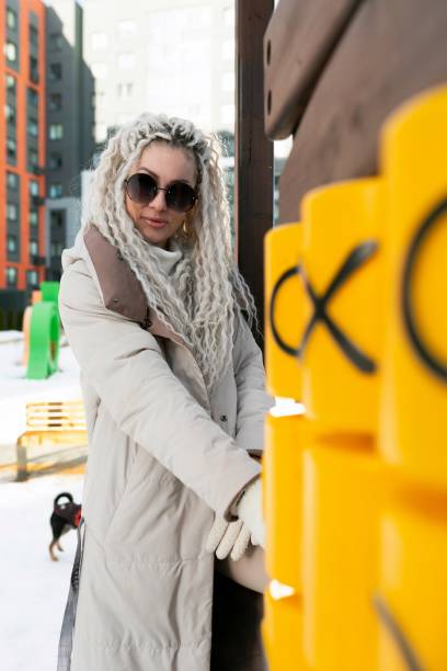 istock Woman With White Dreadlocks Standing Next to Yellow Post 2173003425