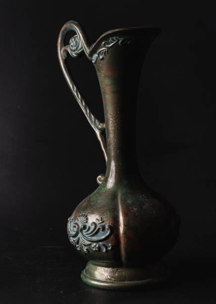 istock Antique carved iron jug or vase on Black background. 2173003593