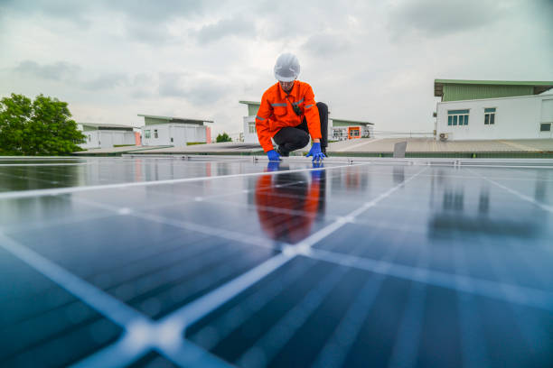 istock engineer man inspects construction of solar cell panel or photovoltaic cell by electronic device. Industrial Renewable energy of green power. factory worker working on tower roof. 2173004352