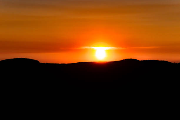 Silhouette of Orange Sunset Under Mountain Range in Washington