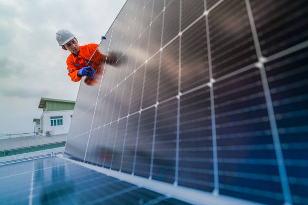 istock engineer man inspects construction of solar cell panel or photovoltaic cell by electronic device. Industrial Renewable energy of green power. factory worker working on tower roof. 2173005325